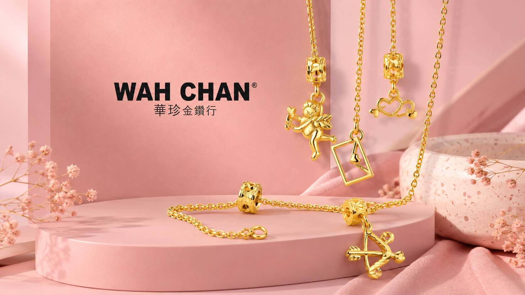 Elegant gold jewelry including necklaces and bracelets from Wah Chan on pink background.
